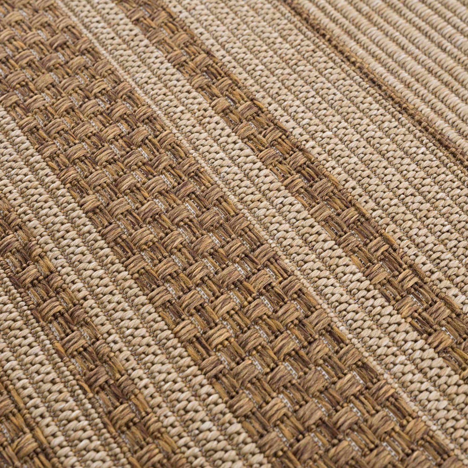 Close-up of the Isoko Bordered Faux Jute Rug, showing woven texture and striped pattern in camel and brown tones. Texture