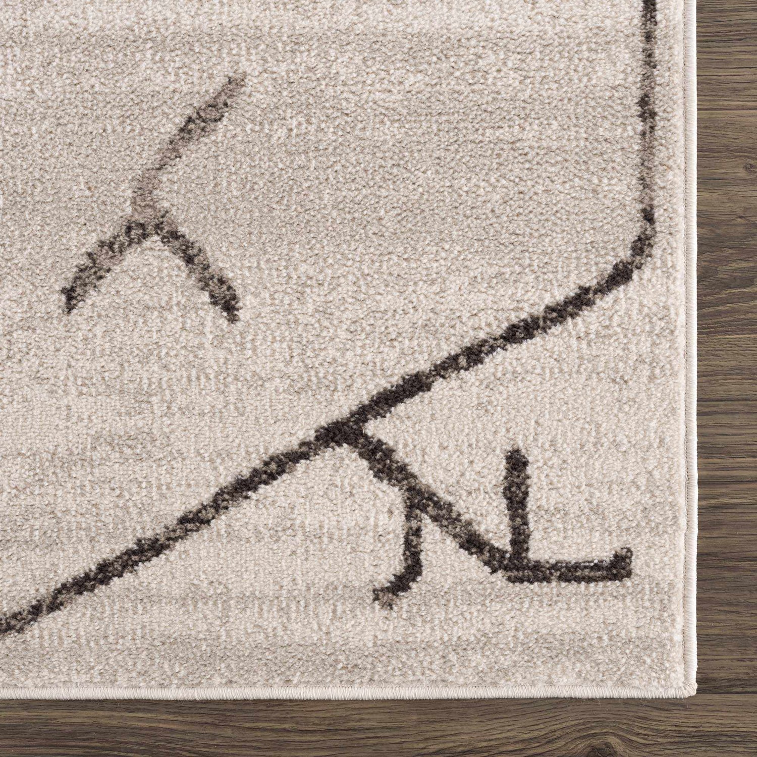 Close-up of Azzan Cream & Charcoal Area Rug showing the cream base and charcoal Southwestern-style geometric pattern. Swatch