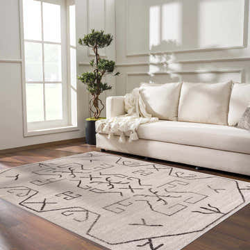 Living room scene with Azzan Cream & Charcoal Area Rug, cream sofa, wood floors, and natural light. Southwestern style. Roomscene-Rectangle
