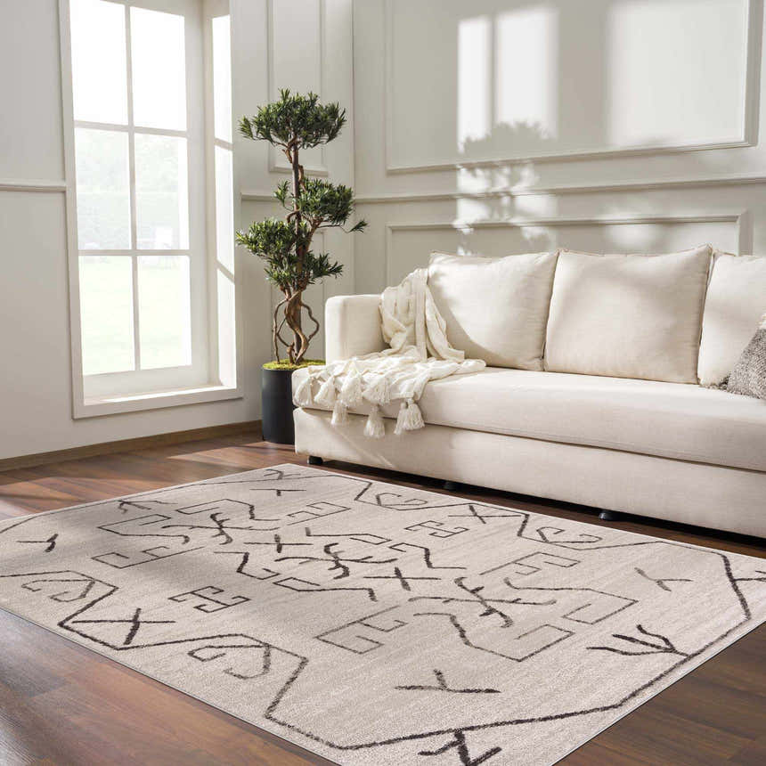 Living room scene with Azzan Cream & Charcoal Area Rug, cream sofa, wood floors, and natural light. Southwestern style. Roomscene-Rectangle