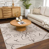 Living room scene with Azzan Cream & Charcoal Area Rug, wood furniture, cream sofa, and indoor plant. Roomscene-Rectangle