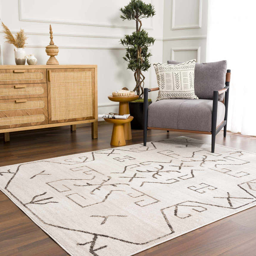 Living room scene with Azzan Cream & Charcoal Area Rug, wood cabinet, gray chair, and Southwestern style decor. Roomscene-Rectangle