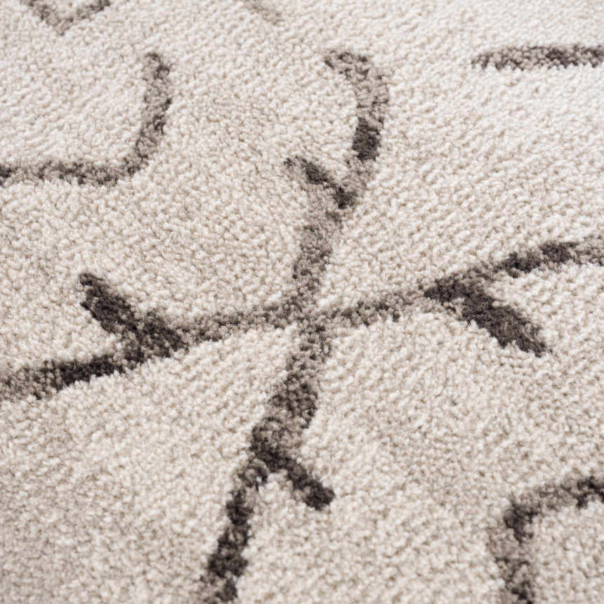 Close-up of the Azzan Cream & Charcoal Area Rug showing its textured weave and Southwestern-inspired charcoal pattern. Texture
