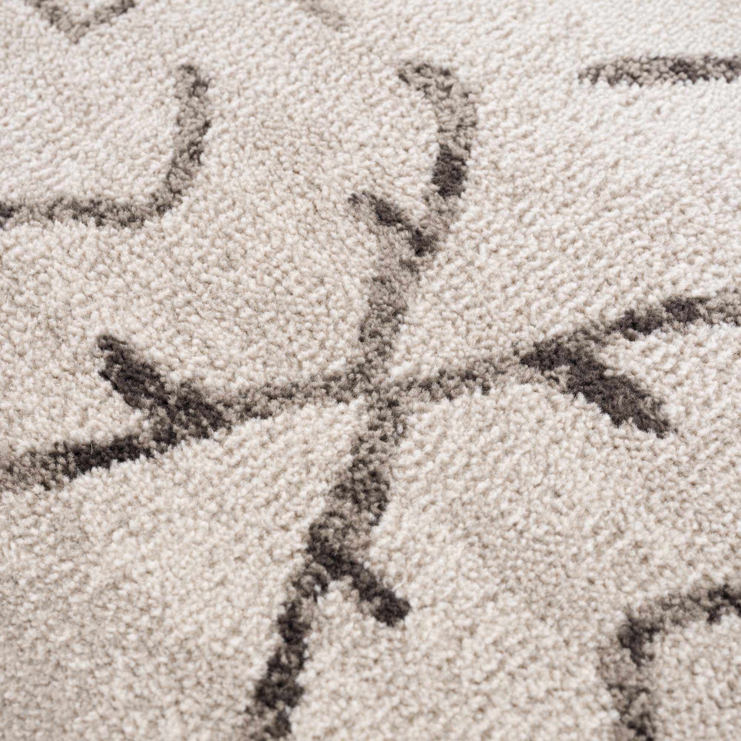 Close-up of the Azzan Cream & Charcoal Area Rug showing its textured weave and Southwestern-inspired charcoal pattern. Texture