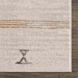 Close-up of the Deja Cream & Gold Area Rug showing its cream color, gold accents, and geometric design. Swatch