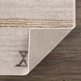 Close-up of the Deja Cream & Gold Area Rug showing the cream color, gold accents, soft texture, and rug backing. Fold