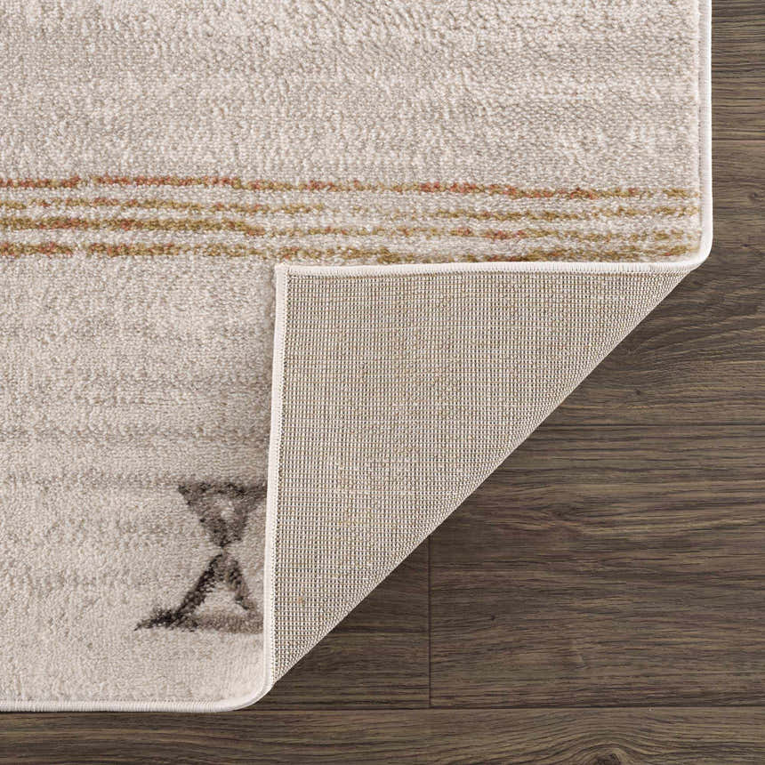 Close-up of the Deja Cream & Gold Area Rug showing the cream color, gold accents, soft texture, and rug backing. Fold