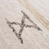 Close up of Deja Cream & Gold Area Rug showing the cream texture and geometric gold and gray pattern. Texture