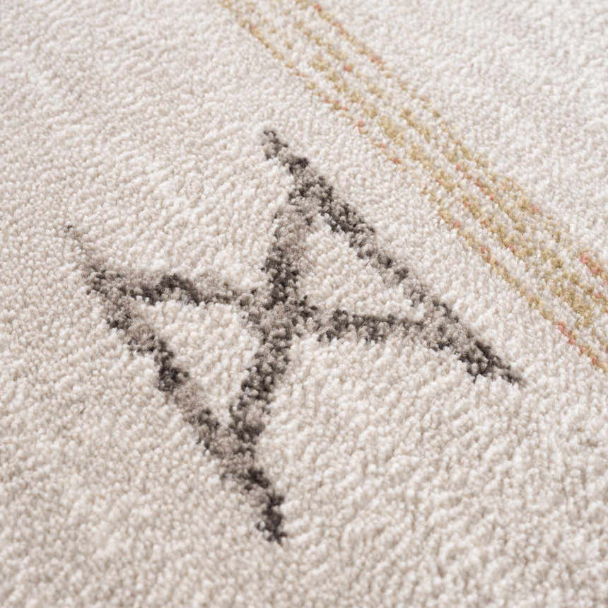 Close up of Deja Cream & Gold Area Rug showing the cream texture and geometric gold and gray pattern. Texture
