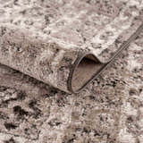 Close-up of the Albie Charcoal & Beige Area Rug showing its abstract pattern and soft, textured pile. Fold