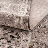 Close up of the Albie Charcoal & Beige Area Rug showing its plush texture, neutral colors, and woven backing. Fold