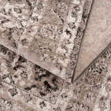 Close-up of the Albie Charcoal & Beige Area Rug showing its traditional pattern, soft texture, and woven backing. Fold