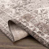Close-up of the Albie Charcoal & Beige Area Rug showing its traditional pattern, soft texture, and durable machine-woven construction. Fold