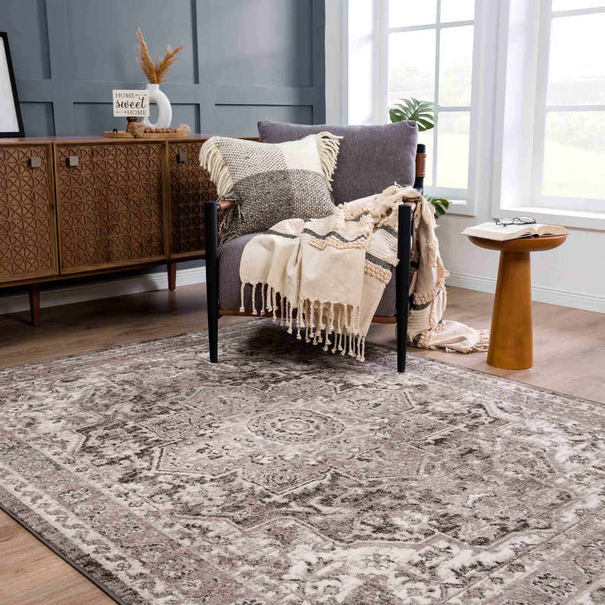 Cozy living room scene with a charcoal chair, wood cabinet, and the Albie Charcoal & Beige Area Rug. Roomscene-Rectangle