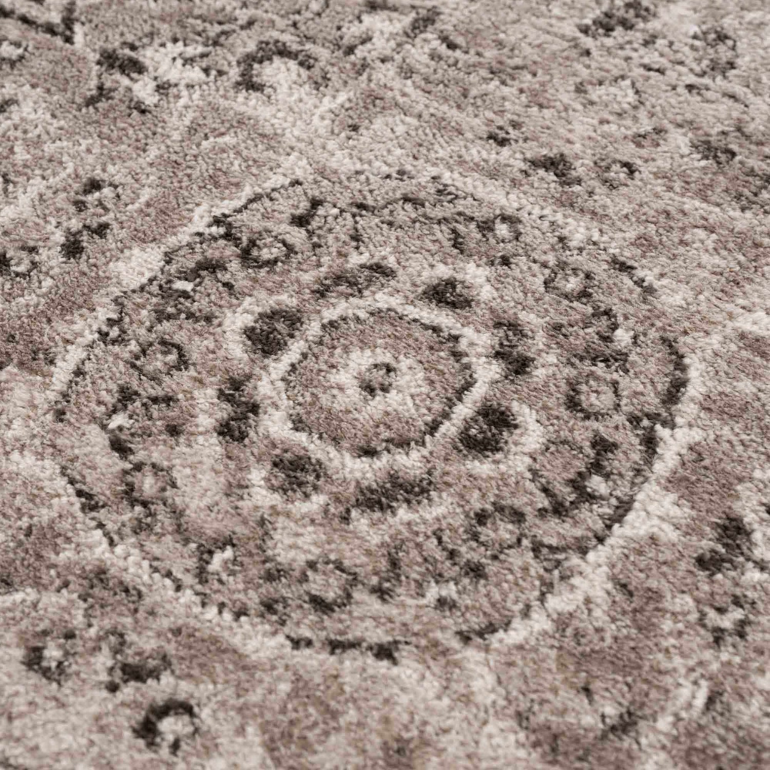 Close-up of the Albie Charcoal & Beige Area Rug showing its traditional medallion pattern and soft, textured pile. Texture