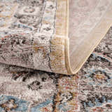 Close-up of the Albie Gold & Beige Area Rug showing its traditional vintage pattern, texture, and beige polypropylene backing. Fold