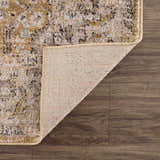 Close-up of the Anana Gold & Beige Area Rug showing its traditional pattern, soft texture, and durable machine-woven construction. Fold
