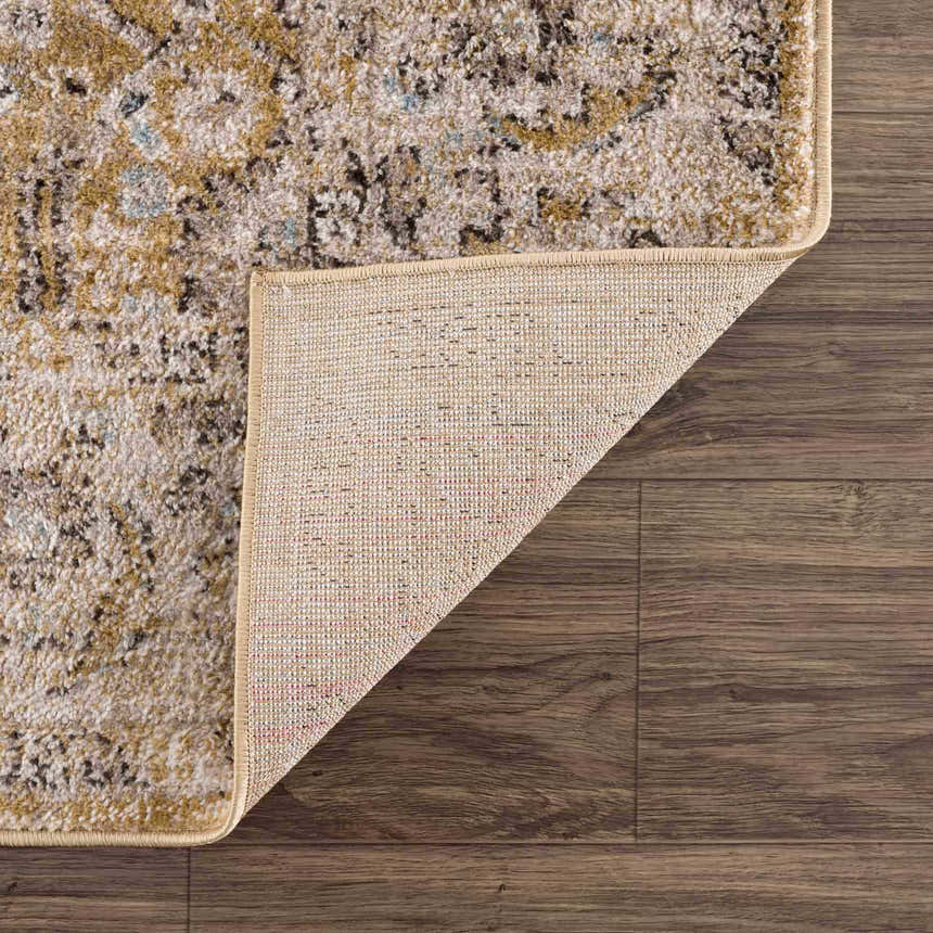 Close-up of the Anana Gold & Beige Area Rug showing its traditional pattern, soft texture, and durable machine-woven construction. Fold