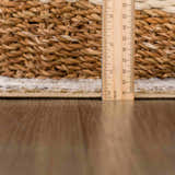 Close-up of the Anana Gold & Beige Area Rug showing the pile height with a ruler on a wood floor. Pile
