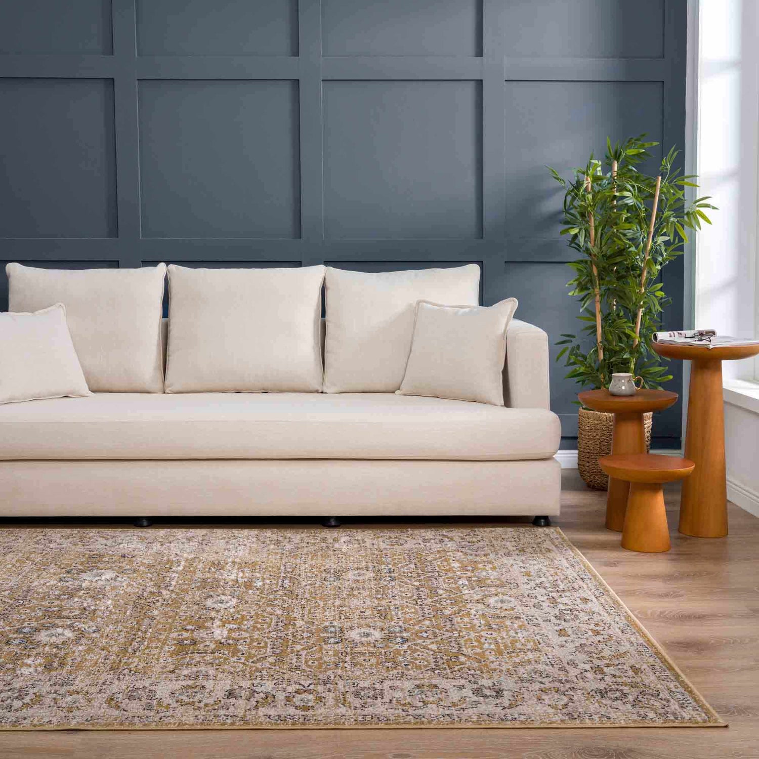 Living room scene with beige sofa, wood side tables, and Anana Gold & Beige Area Rug. Roomscene-Rectangle