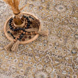 Close-up of the Anana Gold & Beige Area Rug showing its traditional pattern and soft gold and beige colors. Styleshot