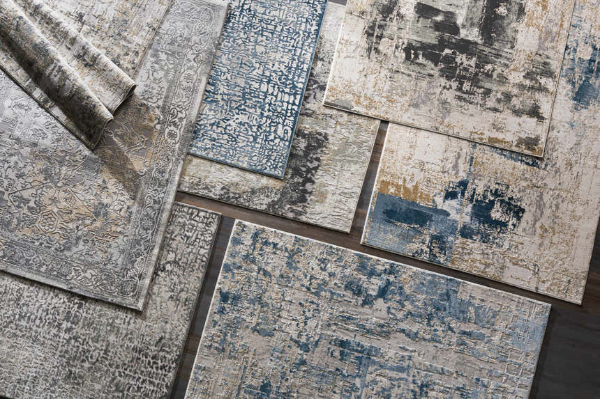 Close-up of Larne Area Rug - Clearance, featuring blue, gray, and beige colors in a vintage, contemporary design. Styleshot