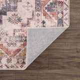 Close-up of the Isugod Washable Area Rug showing its beige, black, and brick red traditional Southwestern pattern and non-slip backing. Fold