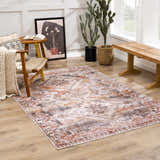 Living room scene with the Isugod Washable Area Rug in beige, brick red, and black, styled with a chair and wooden bench. Roomscene-Rectangle