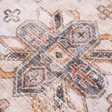 Close-up of the Isugod Washable Area Rug showing beige, black, and brick red traditional pattern. Texture