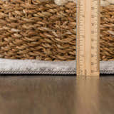 Close-up of the Kalanganan Abstract Gray Rug showing rug thickness with a ruler and woven basket for texture comparison. Pile