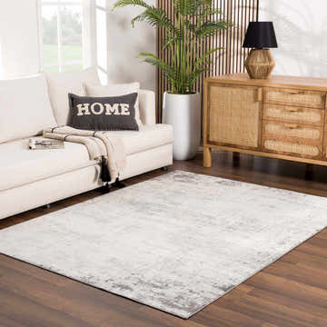 Living room scene with a Kalanganan Abstract Gray Rug, cream sofa, and wood cabinet. Modern, neutral tones. Roomscene-Rectangle