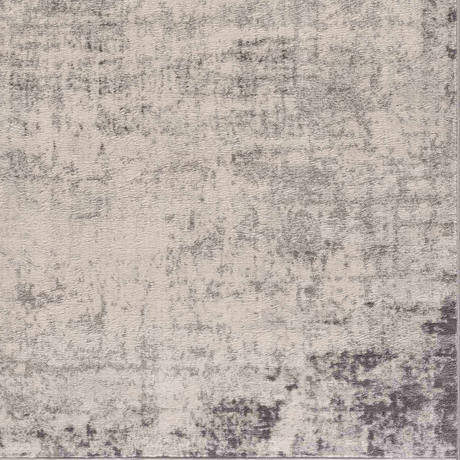 Close-up of the Kalanganan Abstract Gray Rug, featuring a blend of charcoal, light gray, and off-white hues. Swatch