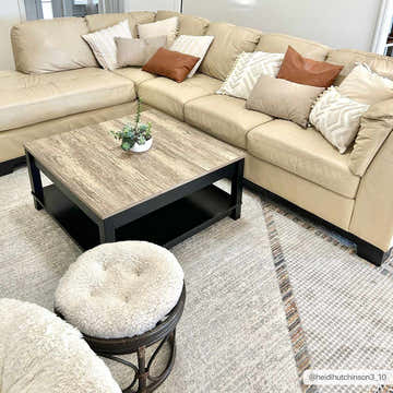 Living room scene with a beige sectional, wood coffee table, and Remy Washable Area Rug in a geometric pattern. Roomscene-Rectangle