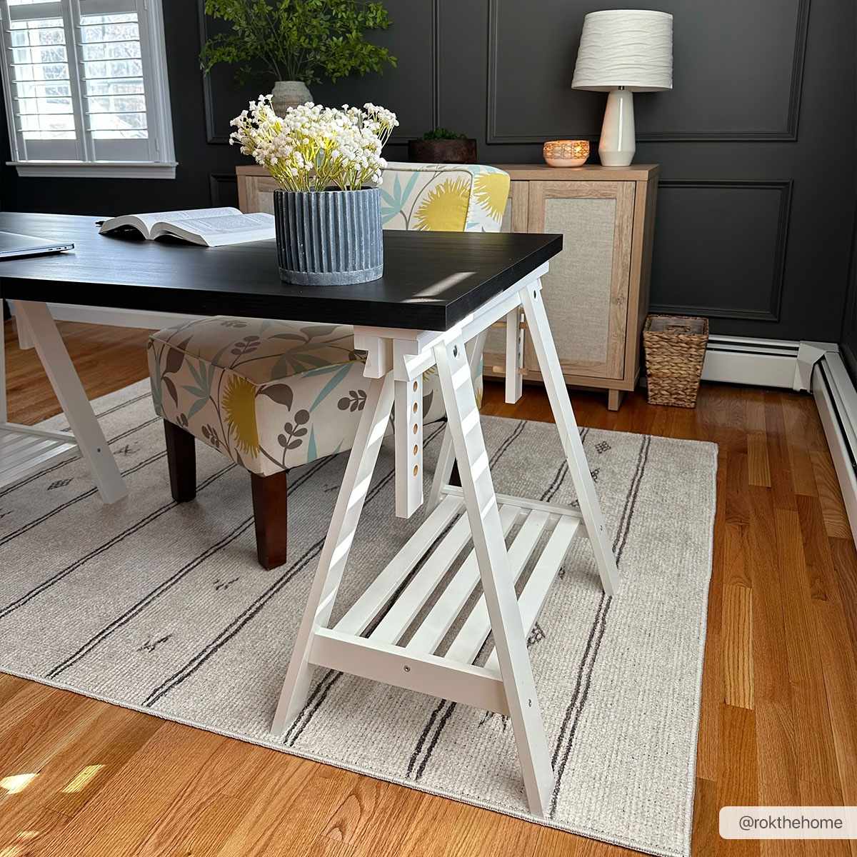 Home office with Rivi Moroccan Beige rug, black desk, wood floors, and dark gray walls. Roomscene-Rectangle