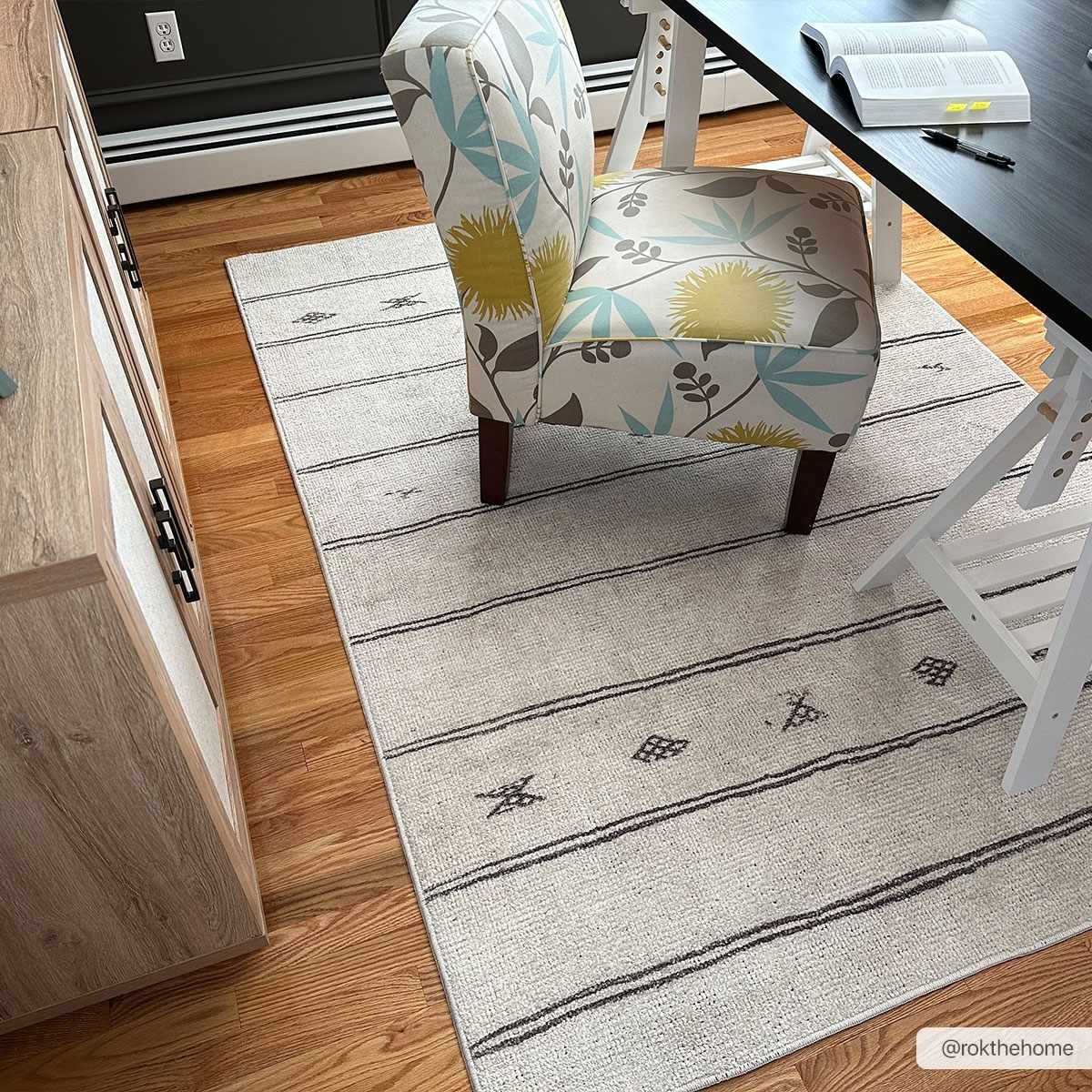 Home office with Rivi Moroccan Beige rug, floral chair, wood floors, and black desk. Roomscene-Rectangle