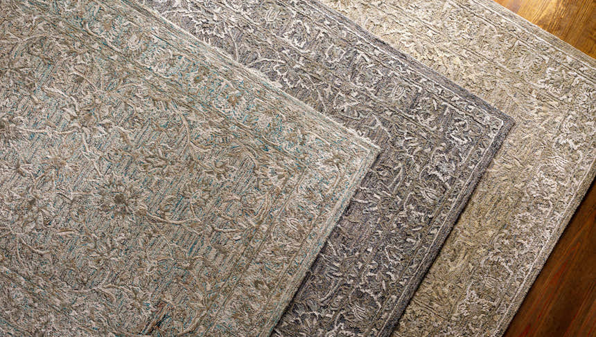 Close-up of Eriline Wool & Faux Silk Rug in denim, sage, and taupe. Hand-tufted rug with a traditional, floral-inspired pattern. Styleshot