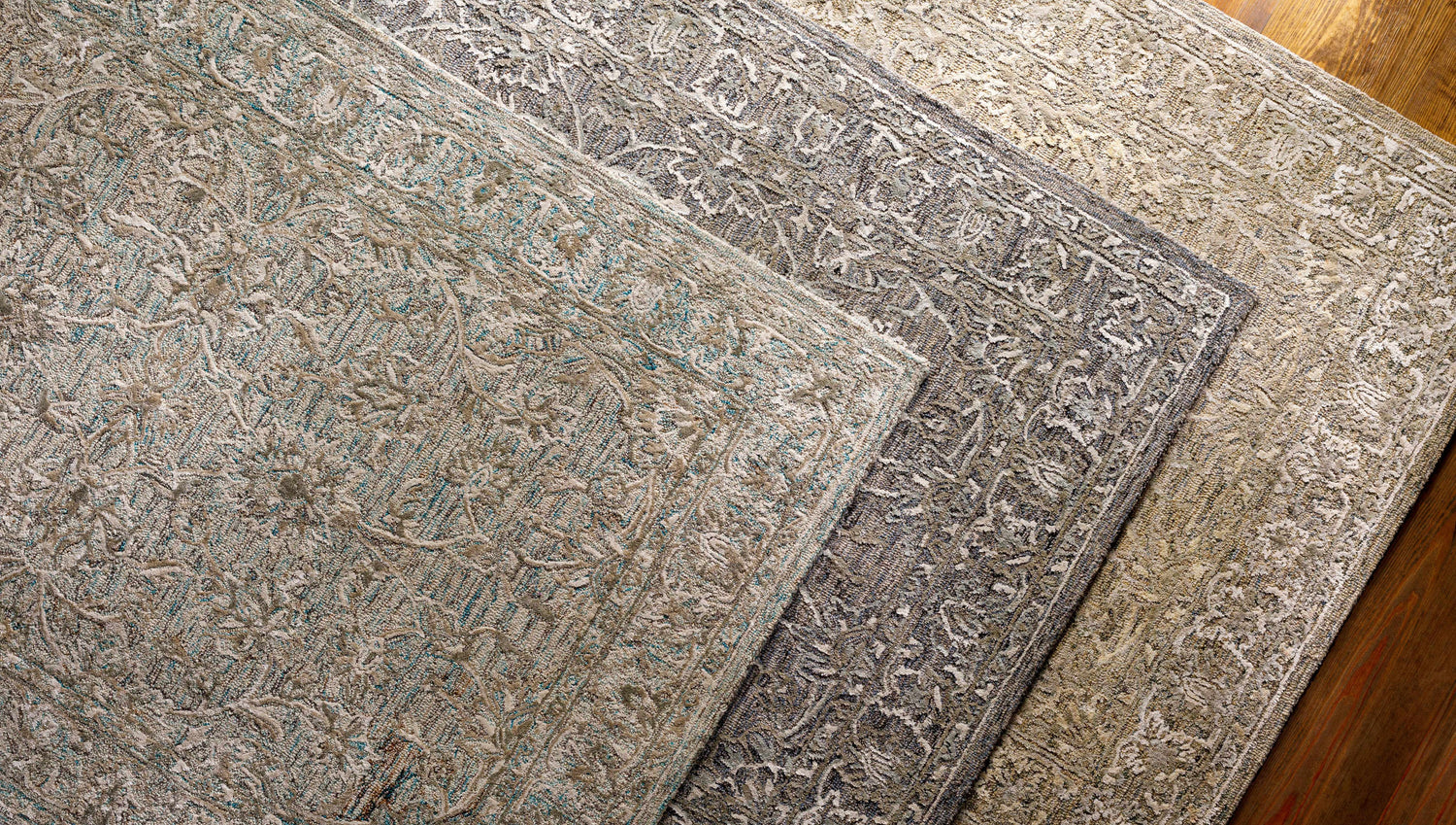 Close-up of Eriline Wool & Faux Silk Rug in denim, sage, and taupe. Hand-tufted rug with a traditional, floral-inspired pattern. Styleshot