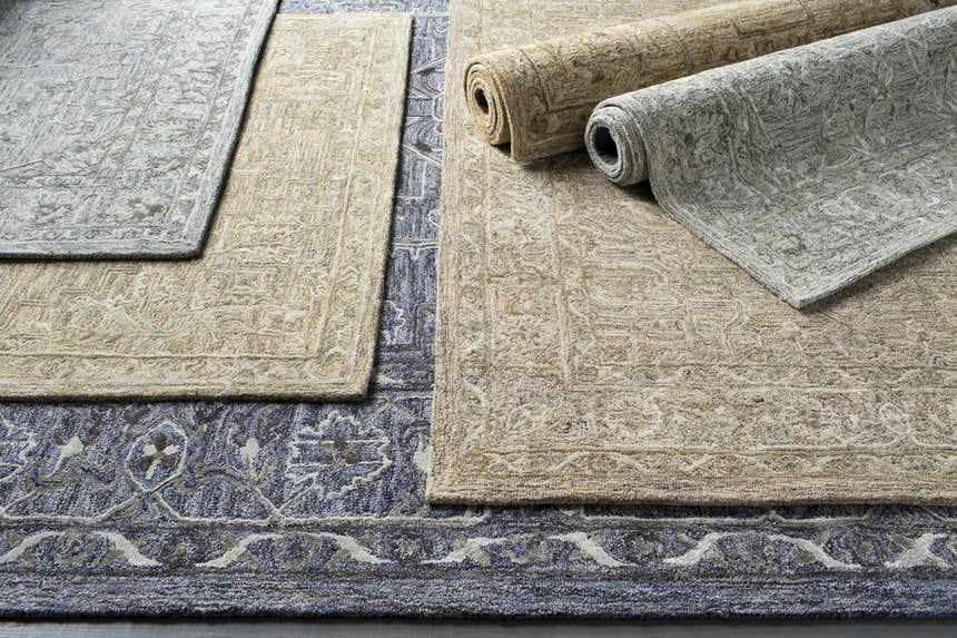 Close-up of Eriline Wool & Faux Silk Rugs in denim, ivory, and sage. Hand-tufted rugs showing texture and traditional patterns. Styleshot