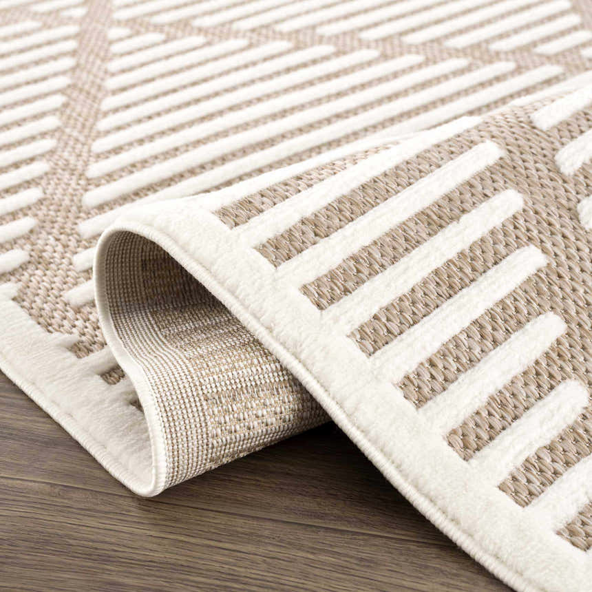 Close-up of Anah Cream Outdoor Rug featuring a geometric pattern in bone and white thatch colors. Fold