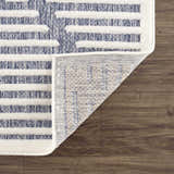 Close-up of Anah Blue Outdoor Rug showing the blue and off-white stripe design and the rug's construction. Fold