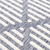 Close-up of Anah Blue Outdoor Rug featuring a textured, geometric pattern in denim and off-white hues. Texture