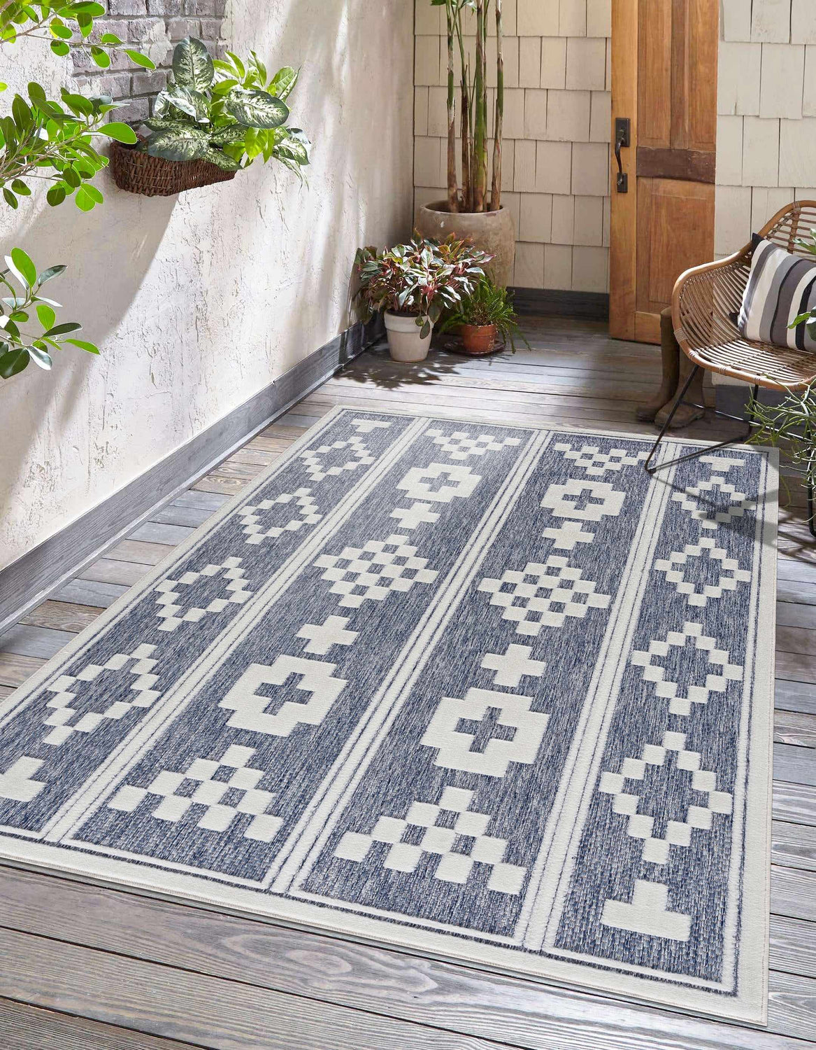 Outdoor patio scene with blue and white geometric Hiro Blue Outdoor Rug. Roomscene-Rectangle