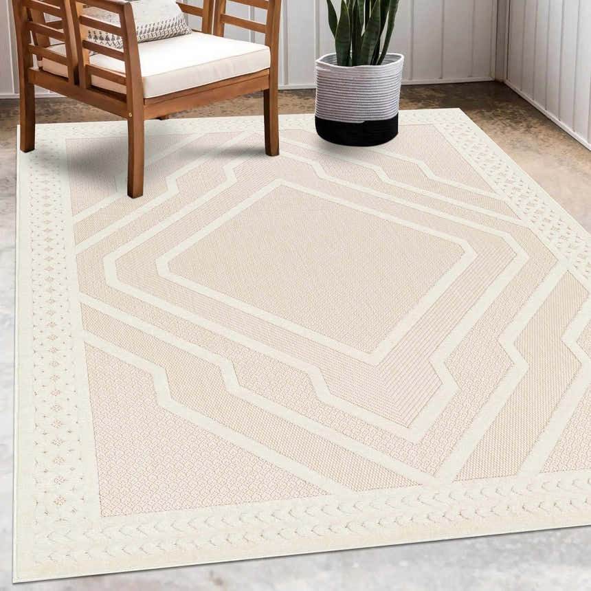 Patio scene with wood chair and Anja Cream Outdoor Rug, featuring a geometric design and durable polypropylene material. Roomscene-Rectangle