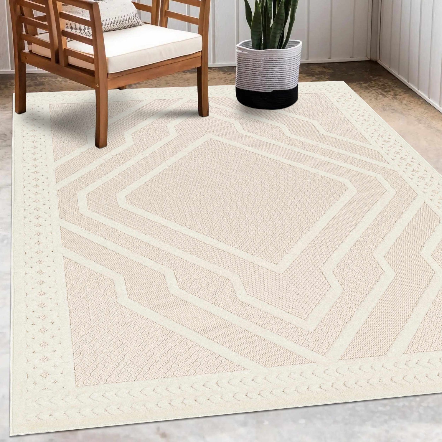 Patio scene with wood chair and Anja Cream Outdoor Rug, featuring a geometric design and durable polypropylene material. Roomscene-Rectangle