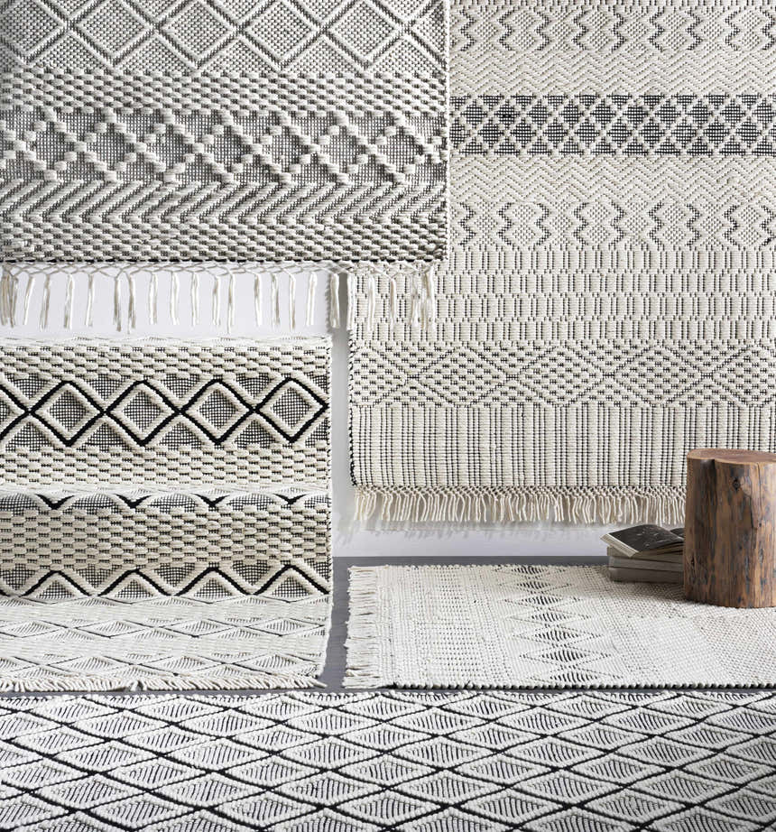 Close-up of Limoges Area Carpet showing geometric patterns, hand woven texture, black and cream colors. Styleshot