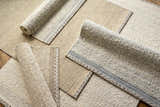 Close-up of Dalaoig Flat Woven Wool Rugs in cream, beige, and gray. Hand-woven texture with stripe detail. Styleshot