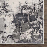 Close-up of the Junko Gray & Blue Marble Area Rug. Features a contemporary abstract design in light gray, blue, and charcoal tones. Swatch