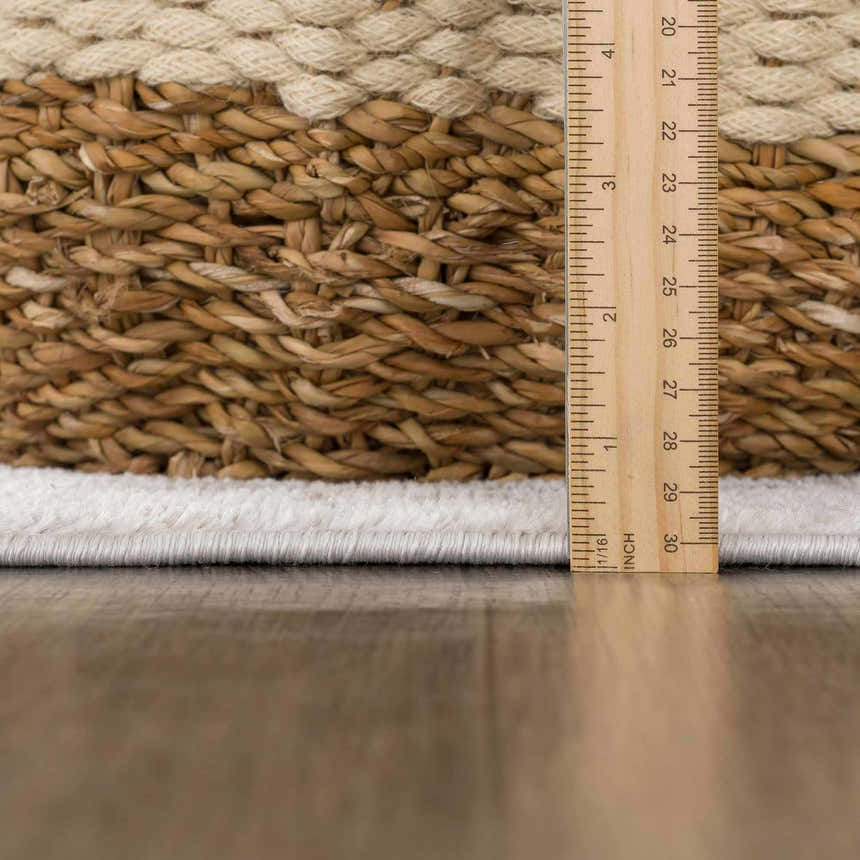 Close-up of Mudgee Area Rug showing cream pile height and tan weave texture with ruler for scale. Pile