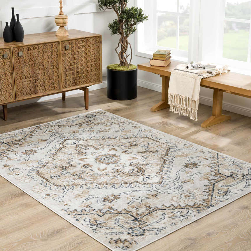 Living room scene with a Mudgee Area Rug in charcoal, cream, and beige, styled with a wooden cabinet and bench. Roomscene-Rectangle