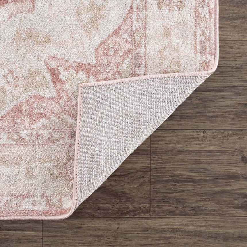 Close-up of the Kandos Blush & Light Pink Area Rug showing its cream, beige, and pink traditional pattern and woven texture. Fold